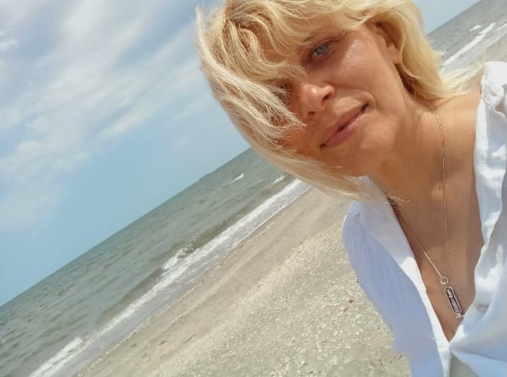 Larisa standing by the sea